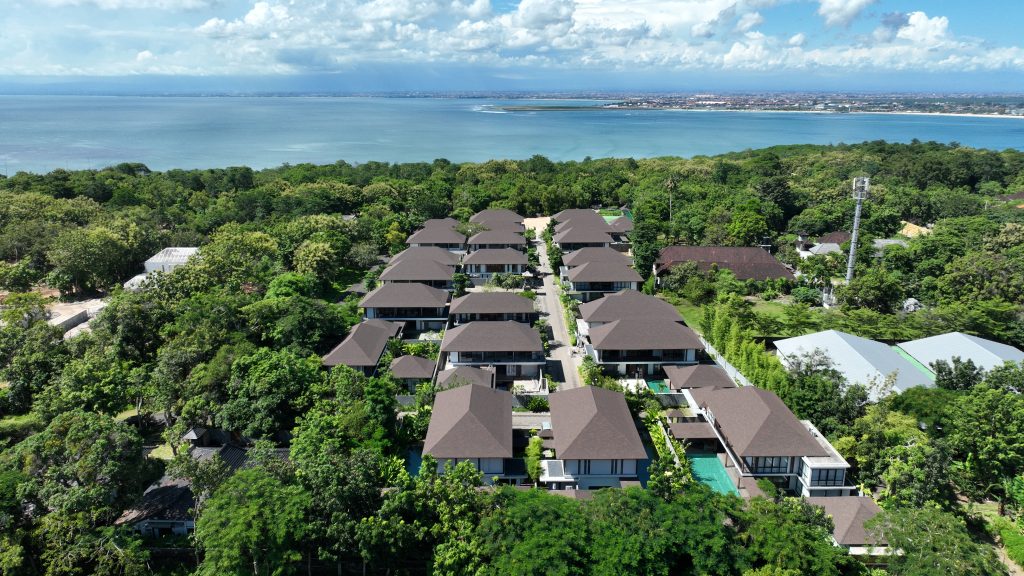 Aerial view of a modern luxury villa surrounded by tropical gardens in Bali, representing luxury living and serene lifestyle